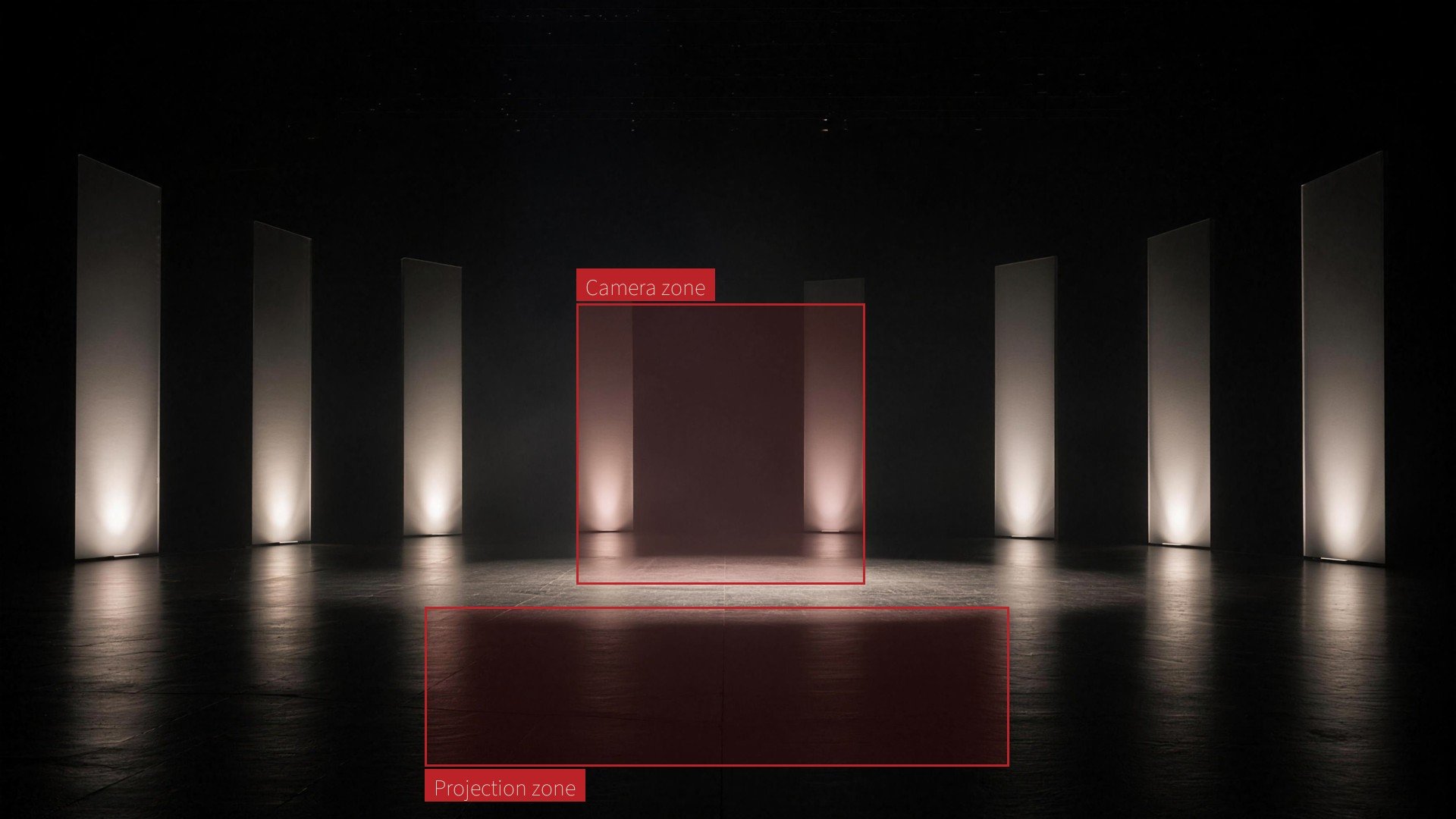 A minimalist dark stage with an arc of tall glowing light panels around an empty pool of light